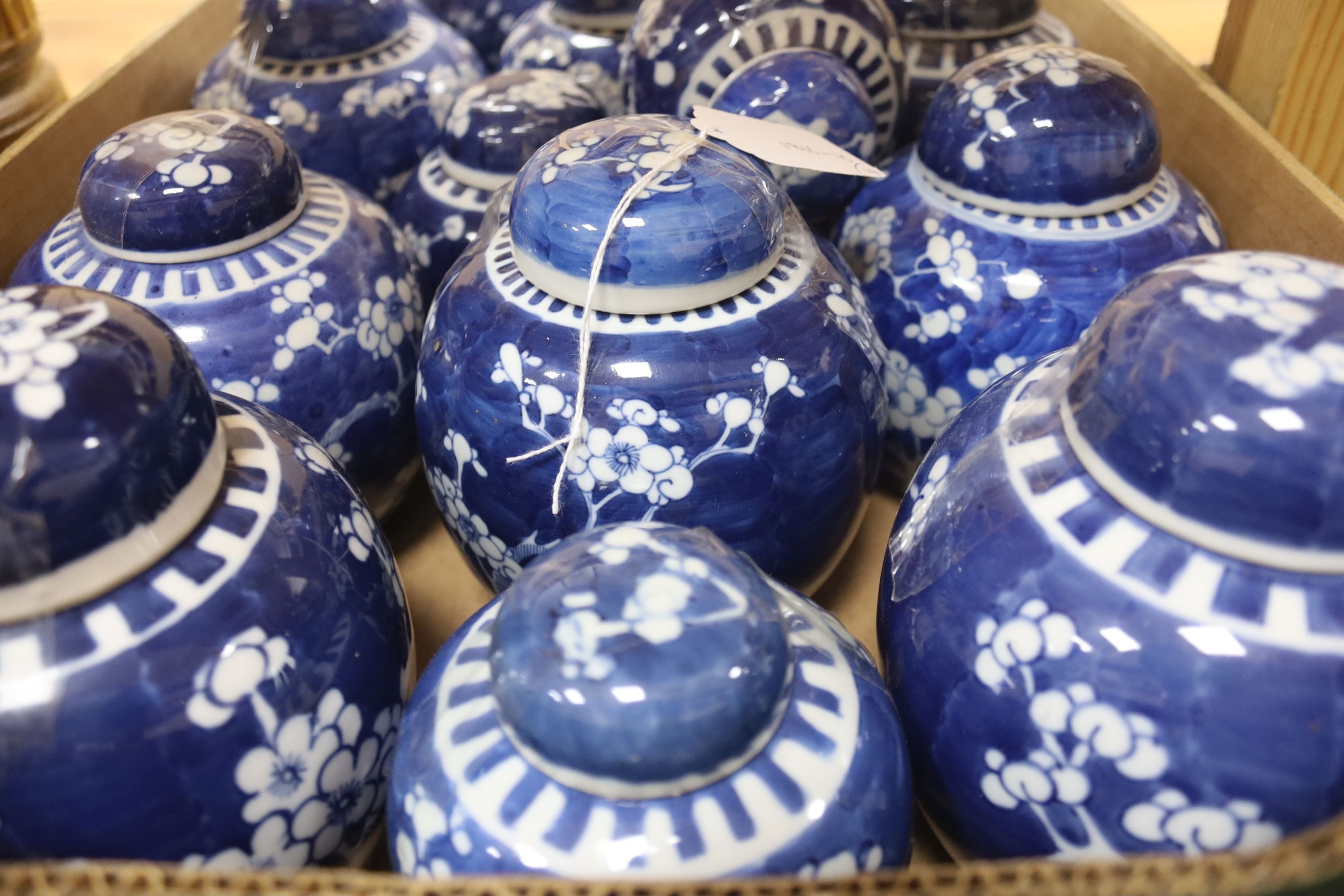 Fourteen Chinese blue and white 'prunus' jars, some with covers